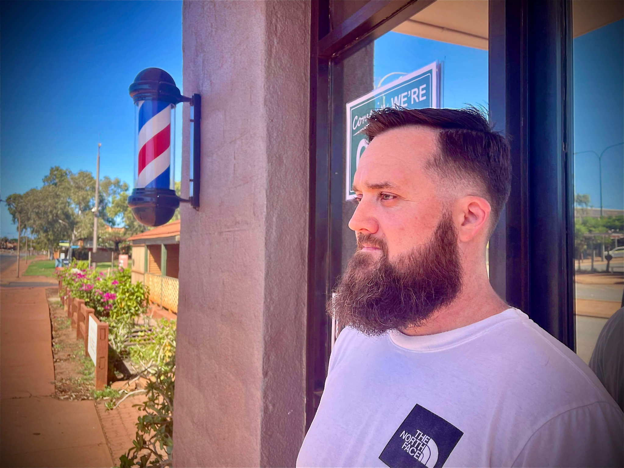 Barber pole on the shop pillar, Port Hedland street behind